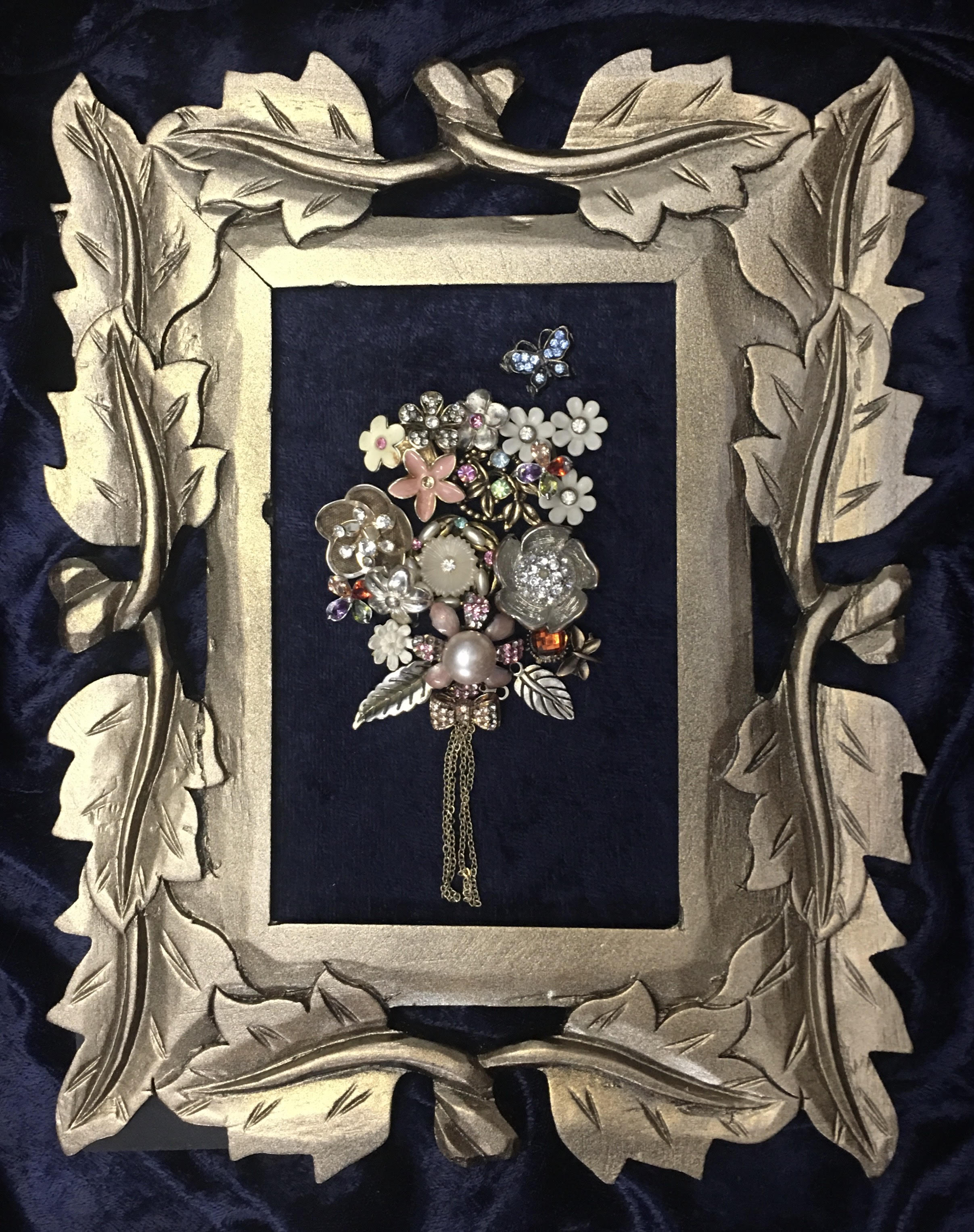 Frame with jewelry laid out on it.